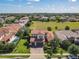 Charming two-story home with a tile roof, a brick driveway, a two car garage and landscaped front yard at 16675 Otterchase Ln, Winter Garden, FL 34787
