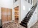 Grand foyer with a staircase, wooden floors, and entry to a living room creating an inviting entrance at 16675 Otterchase Ln, Winter Garden, FL 34787
