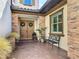 Charming front entrance with double doors, brick accents, a cozy bench and well-maintained landscaping at 16675 Otterchase Ln, Winter Garden, FL 34787