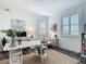 Bright home office with large windows, white desk, and comfortable seating area at 16675 Otterchase Ln, Winter Garden, FL 34787