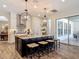 Open kitchen featuring a large center island, counter seating, and stainless steel appliances at 16675 Otterchase Ln, Winter Garden, FL 34787