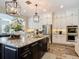 Modern kitchen featuring white cabinets, granite countertops, stainless steel appliances, and hardwood floors at 16675 Otterchase Ln, Winter Garden, FL 34787
