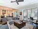 Bright and airy living room with sliding glass doors to an outdoor patio space and an open view to the kitchen at 16675 Otterchase Ln, Winter Garden, FL 34787