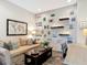 Cozy living room with modern decor, shiplap accent wall, comfortable seating, and a desk area at 16675 Otterchase Ln, Winter Garden, FL 34787