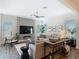 Bright living room with a stone accent wall, modern furnishings, and plenty of natural light at 16675 Otterchase Ln, Winter Garden, FL 34787