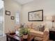 Comfortable living room with modern decor, cozy seating, and a dark wood coffee table at 16675 Otterchase Ln, Winter Garden, FL 34787