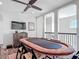 Bright loft featuring a poker table and a large TV perfect for a game room overlooking the staircase at 16675 Otterchase Ln, Winter Garden, FL 34787