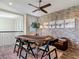 Elegant loft with a poker table, brick accent wall, and a ceiling fan creating a cozy atmosphere for entertainment at 16675 Otterchase Ln, Winter Garden, FL 34787