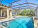 Screened in pool area with patio, tanning chairs, blue umbrella, and water features at 16675 Otterchase Ln, Winter Garden, FL 34787