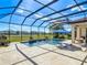 Beautiful screened pool area with elegant fountains and an inviting lounge area, surrounded by lush greenery at 16675 Otterchase Ln, Winter Garden, FL 34787