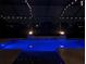 Stunning pool with fire bowls and screened enclosure with string lights for evening enjoyment at 16675 Otterchase Ln, Winter Garden, FL 34787