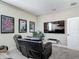 Home theater with tiered seating, leather recliners, a flat-screen TV, and movie-themed wall art at 16675 Otterchase Ln, Winter Garden, FL 34787