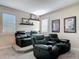 Home theater featuring tiered seating with leather recliners, carpet, and wall decor at 16675 Otterchase Ln, Winter Garden, FL 34787