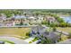 An aerial view captures the home's location near a tranquil lake and lush green spaces at 1671 Thetford Cir, Orlando, FL 32824