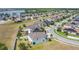 An aerial view shows houses with solar panels and a beautiful view of a pond at 1671 Thetford Cir, Orlando, FL 32824