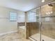 Bathroom with tiled floor, separate shower, and soaking tub with stone surround at 1671 Thetford Cir, Orlando, FL 32824
