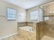 Bathroom featuring tiled floor, soaking tub with tile surround, and separate shower at 1671 Thetford Cir, Orlando, FL 32824