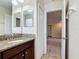 Bathroom featuring granite countertops, double sinks, and access to a bedroom at 1671 Thetford Cir, Orlando, FL 32824