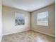 Bedroom featuring neutral walls, tile flooring, and windows with blinds for natural light at 1671 Thetford Cir, Orlando, FL 32824