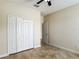 Bedroom features tile flooring, closet with bi-fold doors, and a door to an adjacent room at 1671 Thetford Cir, Orlando, FL 32824