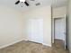 Bedroom features tile flooring, closet with bi-fold doors, and a door to an adjacent room at 1671 Thetford Cir, Orlando, FL 32824