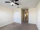 Bedroom featuring a ceiling fan, closet, and access to the hallway at 1671 Thetford Cir, Orlando, FL 32824