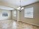 Bright dining room featuring tile floors, a modern chandelier, and plenty of natural light at 1671 Thetford Cir, Orlando, FL 32824