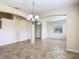 Open dining room with tile floors, arched doorways, and a hanging light fixture at 1671 Thetford Cir, Orlando, FL 32824
