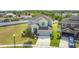 Beautiful exterior view of the home showing the manicured lawn, two-car garage, and lush landscaping at 1671 Thetford Cir, Orlando, FL 32824