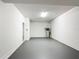 Spacious garage with gray painted floor, white walls, and utility hookups at 1671 Thetford Cir, Orlando, FL 32824