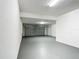 Spacious garage with gray painted floor, white walls, and an insulated garage door at 1671 Thetford Cir, Orlando, FL 32824