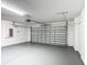 Spacious garage with gray painted floor, white walls, and an insulated garage door at 1671 Thetford Cir, Orlando, FL 32824