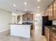 Open kitchen concept with wood cabinets, stainless steel appliances, and convenient access to other rooms at 1671 Thetford Cir, Orlando, FL 32824