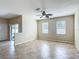 View of the living room with tile floors and sliding glass doors to the outdoor area at 1671 Thetford Cir, Orlando, FL 32824
