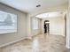 The living room features tile floors, neutral walls, and an archway leading to the kitchen at 1671 Thetford Cir, Orlando, FL 32824