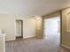 Upstairs loft area with carpet flooring and an arched doorway at 1671 Thetford Cir, Orlando, FL 32824