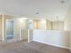 Bright loft area with neutral tones and carpet flooring, showcasing access to other rooms at 1671 Thetford Cir, Orlando, FL 32824