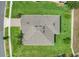 Aerial view of roof on home surrounded by green lawn and mature trees at 1706 Lake Sims Pkwy, Ocoee, FL 34761