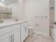 Modern bathroom features dual vanity, quartz countertops and tiled shower at 1706 Lake Sims Pkwy, Ocoee, FL 34761