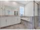 Elegant bathroom features a soaking tub, shower, and double vanity at 1706 Lake Sims Pkwy, Ocoee, FL 34761