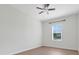 Well-lit bedroom features a ceiling fan and a window with blinds at 1706 Lake Sims Pkwy, Ocoee, FL 34761