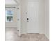 Entryway with white door and neutral tile floor at 1706 Lake Sims Pkwy, Ocoee, FL 34761
