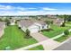 Lovely home features green lawn, brick driveway, landscaping and a view of the community lake nearby at 1706 Lake Sims Pkwy, Ocoee, FL 34761