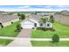 Beautiful single-Gathering home with a well-manicured lawn, brick driveway, and lush landscaping, perfect for curb appeal at 1706 Lake Sims Pkwy, Ocoee, FL 34761