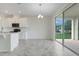 Bright eat-in kitchen boasts white cabinetry, stainless appliances and sliding doors to backyard at 1706 Lake Sims Pkwy, Ocoee, FL 34761
