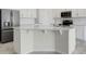 Elegant kitchen island with stone countertop, stainless steel appliances, and ample storage space at 1706 Lake Sims Pkwy, Ocoee, FL 34761