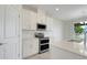 Modern kitchen features stainless steel appliances, white cabinets, quartz countertops at 1706 Lake Sims Pkwy, Ocoee, FL 34761