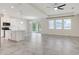 Open-concept living area featuring tile flooring, large windows, and a seamless transition to the kitchen at 1706 Lake Sims Pkwy, Ocoee, FL 34761