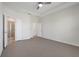 A spacious bedroom featuring a tray ceiling and multiple doors at 1706 Lake Sims Pkwy, Ocoee, FL 34761
