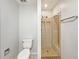 Bathroom features toilet and tile shower stall with built-in bench seating at 1912 Cattleya Dr, Kissimmee, FL 34741